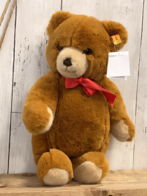 Steiff Plüschspielzeug brauner Bär mit roter Schleife