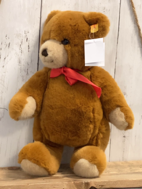 Steiff Plüschspielzeug brauner Bär mit roter Schleife